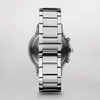 A close-up, top-down view of a men's watch with a silver metal band. Náhľad obrázku produktu