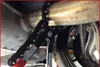 A close-up view of a tool being used to cut an exhaust pipe on a vehicle. Anteprima dell’immagine prodotto