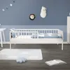 A child's bedroom with a white bed, cloud-themed bedding and rug, and animal wall decorations. Produktbild-Vorschau