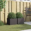 Two black planters with green bushes in front of a wooden fence. Voir les images du produit
