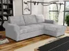 A gray sectional sofa is shown in a living room setting with bookshelves and a window in the background. Náhled obrázku produktu