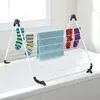 A drying rack for clothes placed over a bathtub. Produktbild-Vorschau