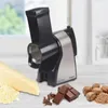 An electric grater is shown on a table with cheese and chocolate. Produktbild-Vorschau