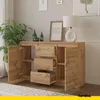 A wooden sideboard with drawers and doors is shown in a room with a plant and artwork. Anteprima dell’immagine prodotto