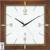 A square wall clock with a wooden frame and a white face. Produktbild-Vorschau