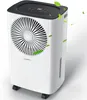 A white dehumidifier with a black top and a circular fan grille on the front, with green leaves floating around it.