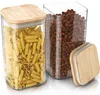 Two glass storage jars with bamboo lids, one filled with pasta and the other with coffee beans. A third bamboo lid is placed next to the jars. Produktbild-Vorschau
