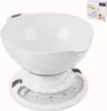 A white mechanical kitchen scale with a white bowl on top, shown against a white background. A small box with the brand logo and an image of the product is in the upper right corner. Voir les images du produit