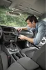 A man is vacuuming the interior of a car. Náhled obrázku produktu