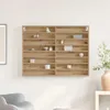 A wooden display shelf with various small decorative items and boxes on it, mounted on a white wall. Náhled obrázku produktu