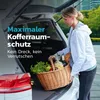 A woman is loading groceries into the trunk of a car. Produktbild-Vorschau