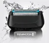 A close-up shot of a black Remington shaver head with water splashing around it, set against a light gray and white background with a reflection of the brand name. Anteprima dell’immagine prodotto