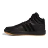 A side view of a black Adidas Hoops 3.0 Mid sneaker with a brown sole, set against a white background. Voir les images du produit
