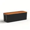 A black cable management box with a wooden lid, shown against a white background. Produktbild-Vorschau