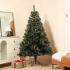 A decorated artificial Christmas tree stands in a room next to a dresser and a gift. Produktbild-Vorschau
