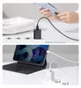 Two images showing a black USB-C charger and a white USB-C charger being used to charge devices. Produktbild-Vorschau