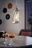 A hanging lantern-style light fixture above a table with drinks and popcorn. Produktbild-Vorschau