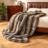 A faux fur blanket draped over a bed in a bedroom setting. Náhled obrázku produktu