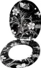 A toilet seat and lid with a black background and a white floral and butterfly pattern. Produktbild-Vorschau