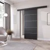 A modern living room with a sliding door, armchair, and floor lamp. Produktbild-Vorschau