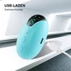 A teal-colored electronic device with a digital display and buttons, connected to a white USB-C cable, placed on a white surface with a blurred modern architectural background. Produktbild-Vorschau