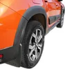 Close-up of the rear wheel and fender area of an orange car, showing black fender flares and a mud flap. Náhľad obrázku produktu