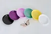 A collection of colorful plant pots and saucers arranged in a semi-circle on a white background, with a decorative butterfly in the center. Náhled obrázku produktu