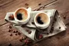 Two cups of coffee with coffee beans and star anise on a wooden table. Produktbild-Vorschau