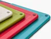 A stack of four colorful cutting boards, viewed from a close-up angle. Podgląd zdjęcia produktu