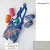 A collection of yarn balls and a crocheted bag on a wooden surface. Produktbild-Vorschau