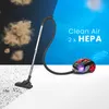 A vacuum cleaner is shown in action, contrasting a dusty environment with a clean, blue environment with text indicating clean air and HEPA filters. Náhľad obrázku produktu