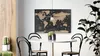 A dining area with a table, chairs, and a world map on the wall. Anteprima dell’immagine prodotto