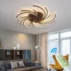 A modern living room with a sofa, armchair, and a ceiling light. Anteprima dell’immagine prodotto