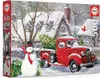 A puzzle box depicting a snowy Christmas scene with a red truck and a snowman. Produktbild-Vorschau