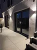 Exterior wall of a modern building at night, illuminated by wall lights. Voir les images du produit