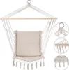 A hanging chair with a cushion, suspended by ropes from a wooden bar. Produktbild-Vorschau