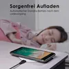 A woman is sleeping in bed while a smartphone is wirelessly charging on a table in the foreground. Produktbild-Vorschau