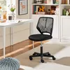 A black office chair is shown in a room with a desk and shelves. Podgląd zdjęcia produktu