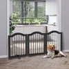 A dog is lying on the floor in front of a black, three-panel pet gate that is set up in a doorway leading to a kitchen. Anteprima dell’immagine prodotto