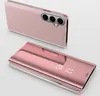 Two pink phone cases are displayed against a light gray background. One case is open, showing the phone inside, while the other is closed, displaying a mirrored surface with time. Produktbild-Vorschau