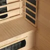 Interior view of a wooden sauna cabin, showing the wooden benches and heating elements. Produktbild-Vorschau