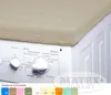 A beige cover is placed on top of a white washing machine, showing its control panel. Voir les images du produit