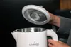 A person's hands are holding the lid of a white electric kettle. Produktbild-Vorschau