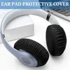 A pair of headphones with black ear pad covers is placed on a white surface next to a laptop. Náhľad obrázku produktu