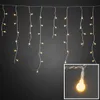 A string of LED icicle lights hanging against a dark background. Produktbild-Vorschau