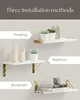 Three different installation methods for white wooden shelves with gold brackets, each shown with decorative items. Produktbild-Vorschau