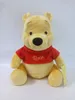 A plush toy of Winnie the Pooh sitting down, wearing a red shirt. Produktbild-Vorschau