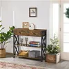 A console table with decorative items and a small Christmas tree in a planter. Produktbild-Vorschau