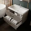 A modern bathroom vanity with an open drawer displaying folded towels and toiletries. Produktbild-Vorschau