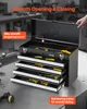 A hand is opening a black metal toolbox with multiple drawers, revealing tools inside. The toolbox is on a workbench. Anteprima dell’immagine prodotto